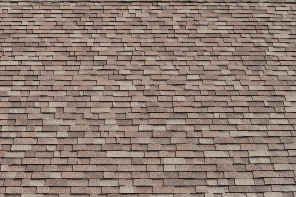 Shingled roof, high pitch. Three tab design.