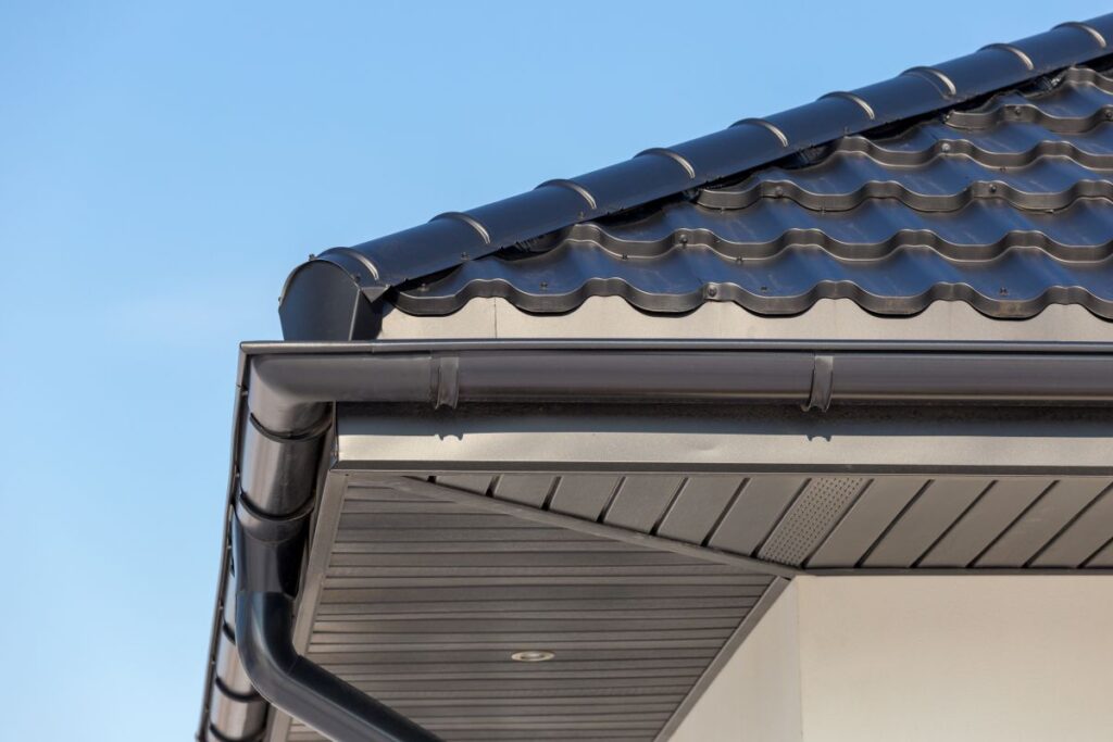 gutter installation types of gutters grey gutter in modern house closeup blue sky