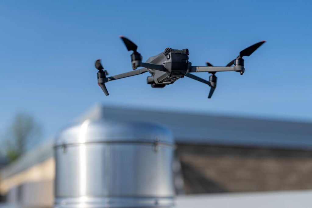 commercial roof inspection black drone on top of building