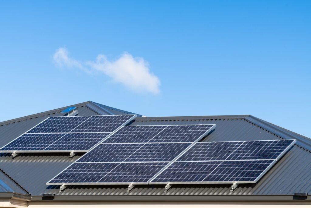 New solar panels installed on metal sheet roof