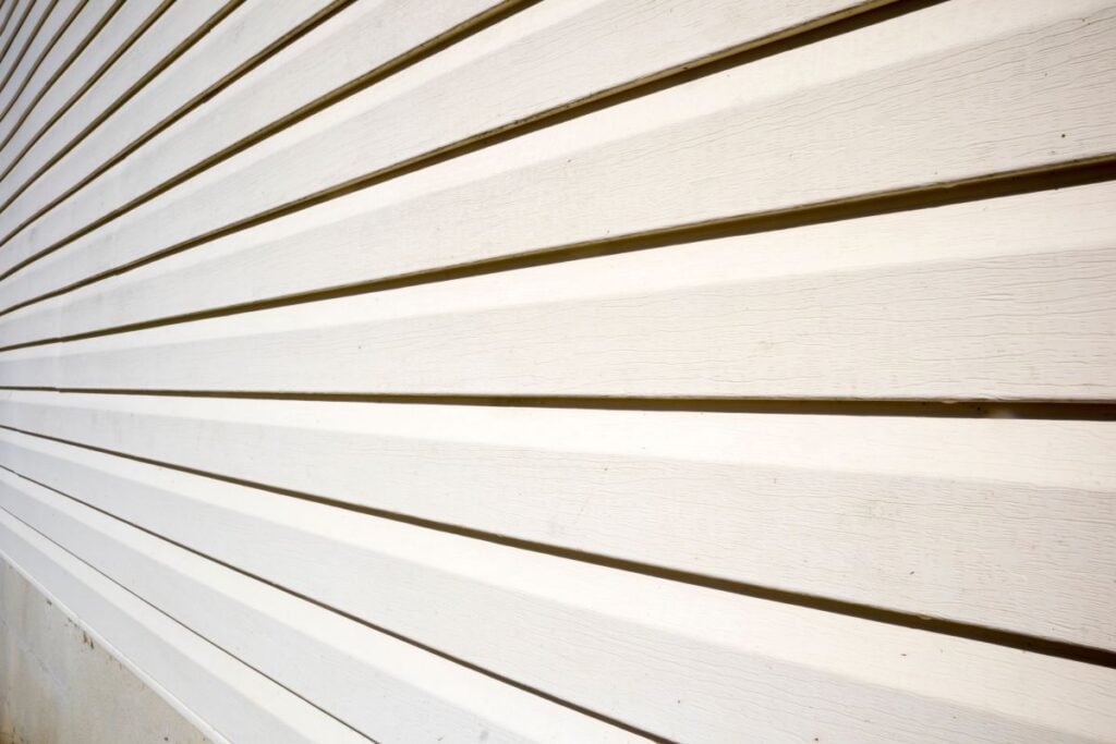 House with pale yellow vinyl siding