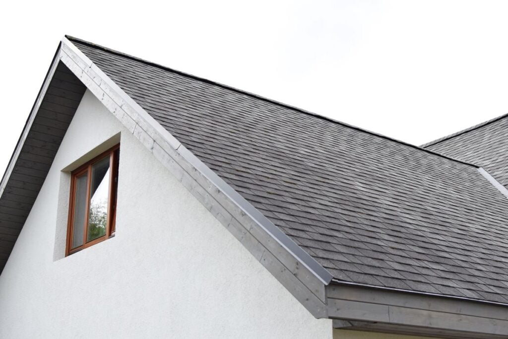 grey asphalt shingles roof with just installed wooden eaves
